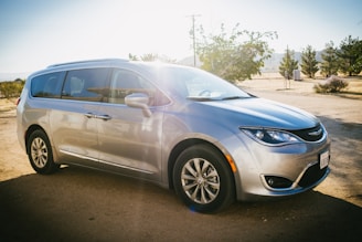 A mobile car detailing van parked in a sunny driveway.