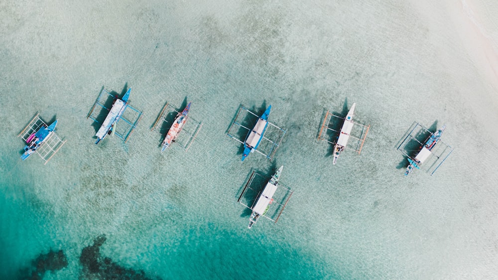 white and blue boat on sea during daytime