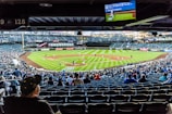 people watching baseball game during daytime