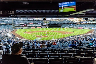 people watching baseball game during daytime