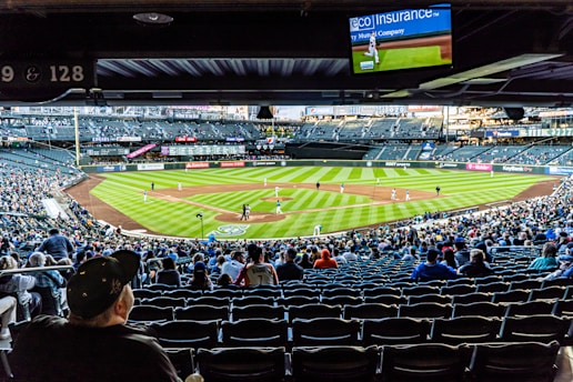 people watching baseball game during daytime