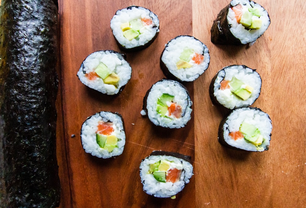 sushi rolls on brown wooden table