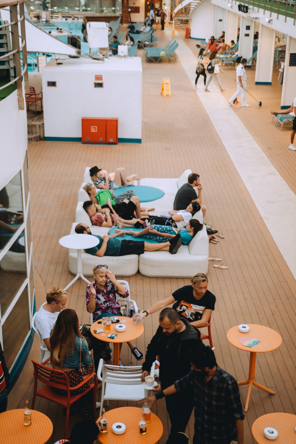 group of people sitting on blue and white chairs