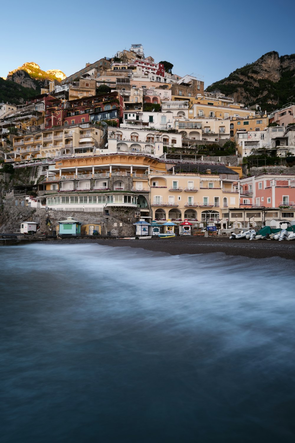 brown and white concrete buildings near body of water during daytime