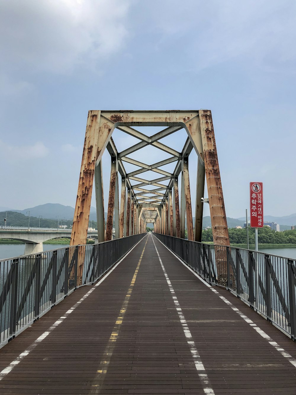 brown wooden bridge over body of water during daytime