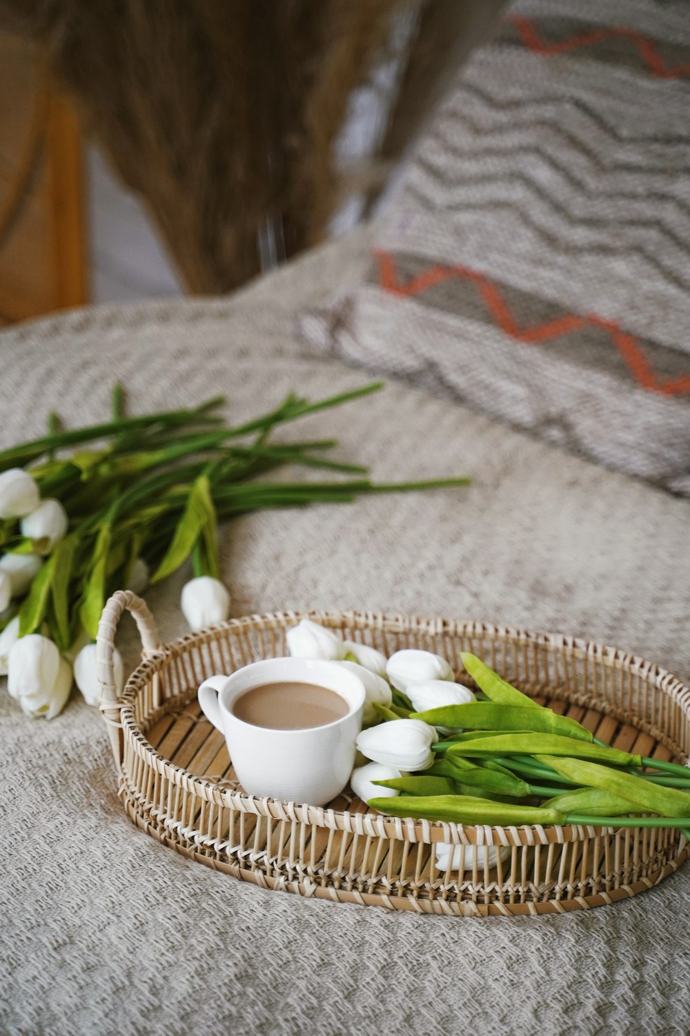 white ceramic mug on brown woven basket