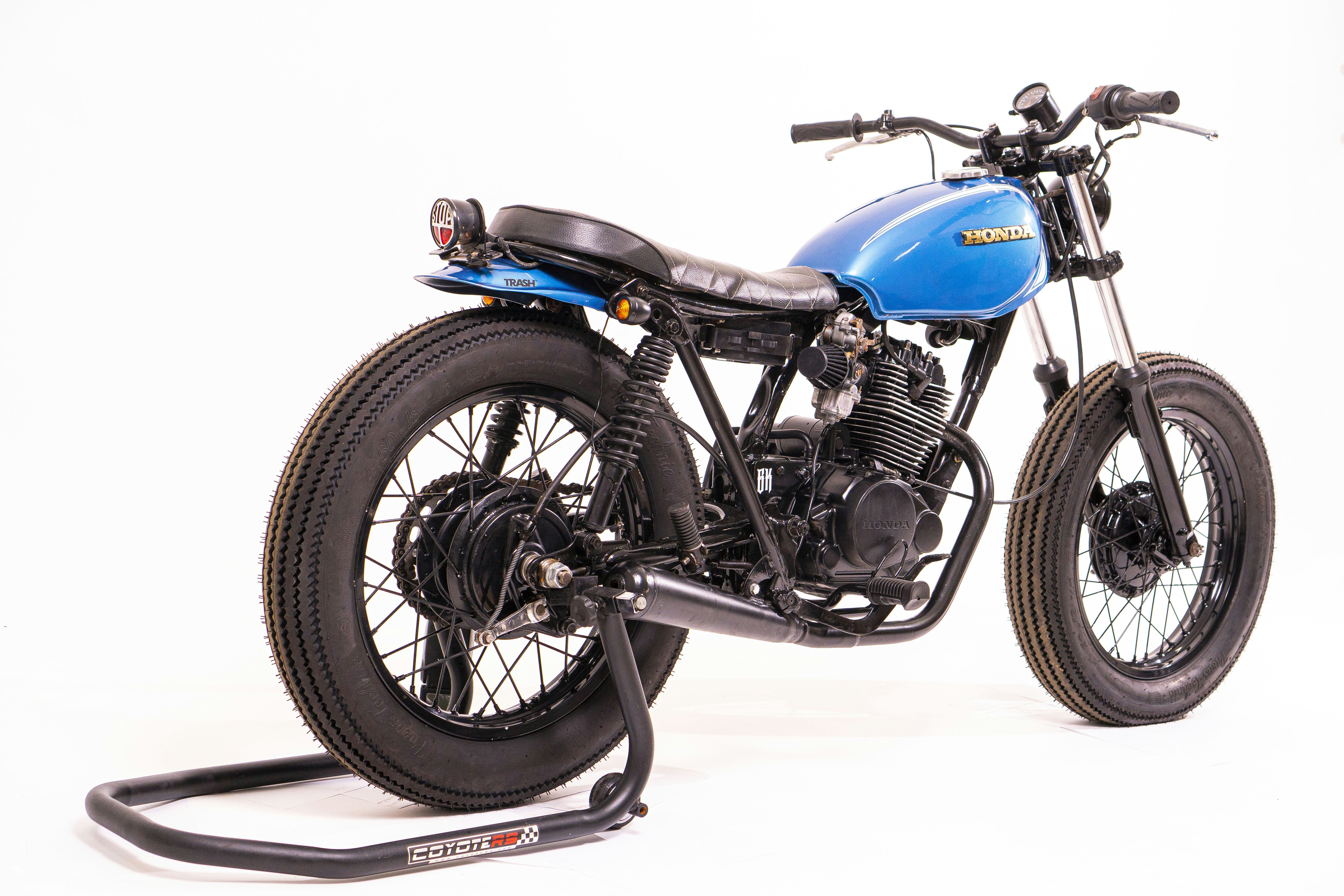 blue and black motorcycle on white surface