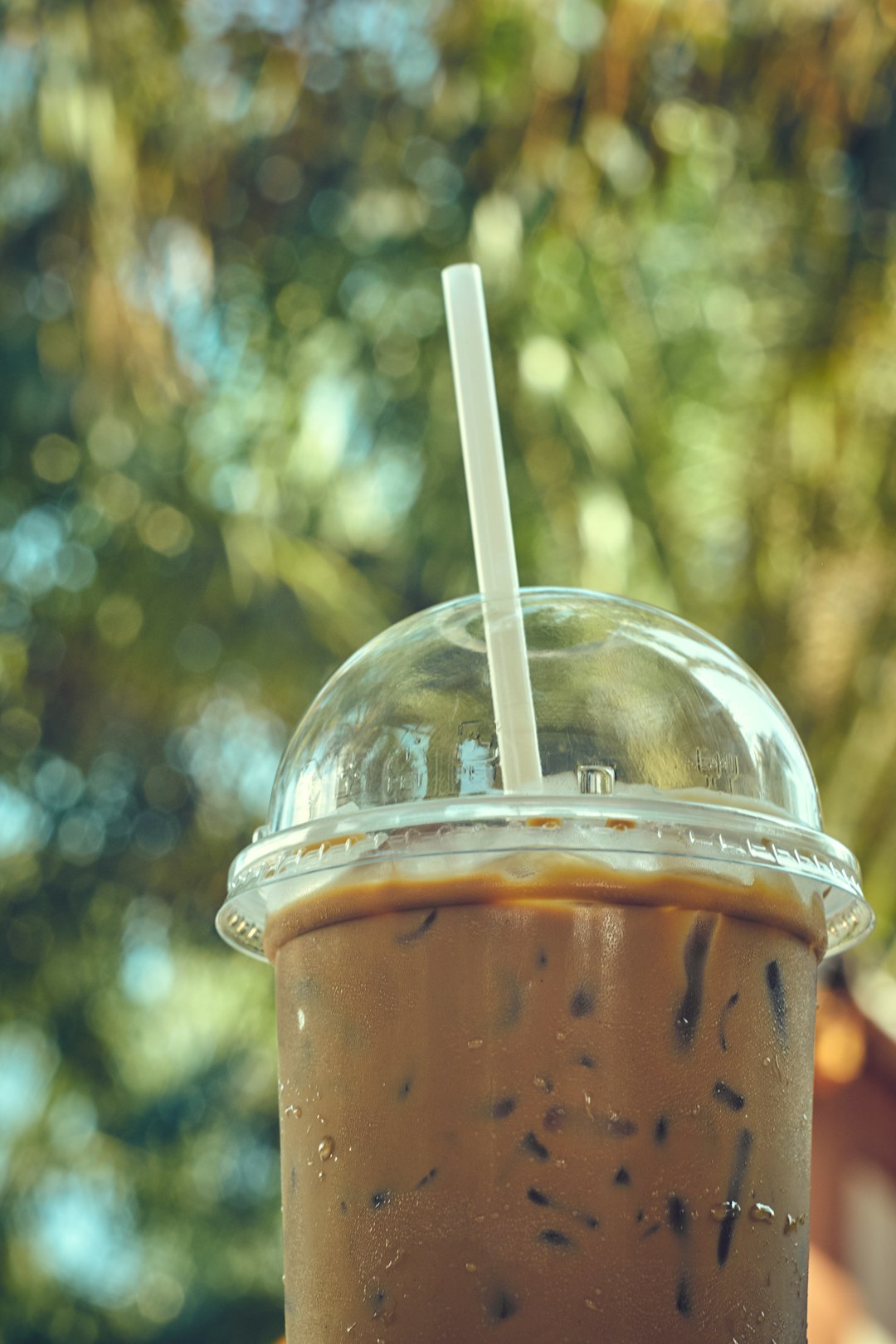 brown liquid in clear plastic cup