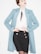 A person is wearing a stylish outfit featuring a long light blue coat over a white blouse with a black tie or accessory at the collar. The outfit is paired with a fitted black skirt adorned with gold buttons. The individual has red lipstick and their hair is styled in an updo.