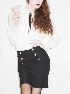 woman in white long sleeve shirt and black skirt