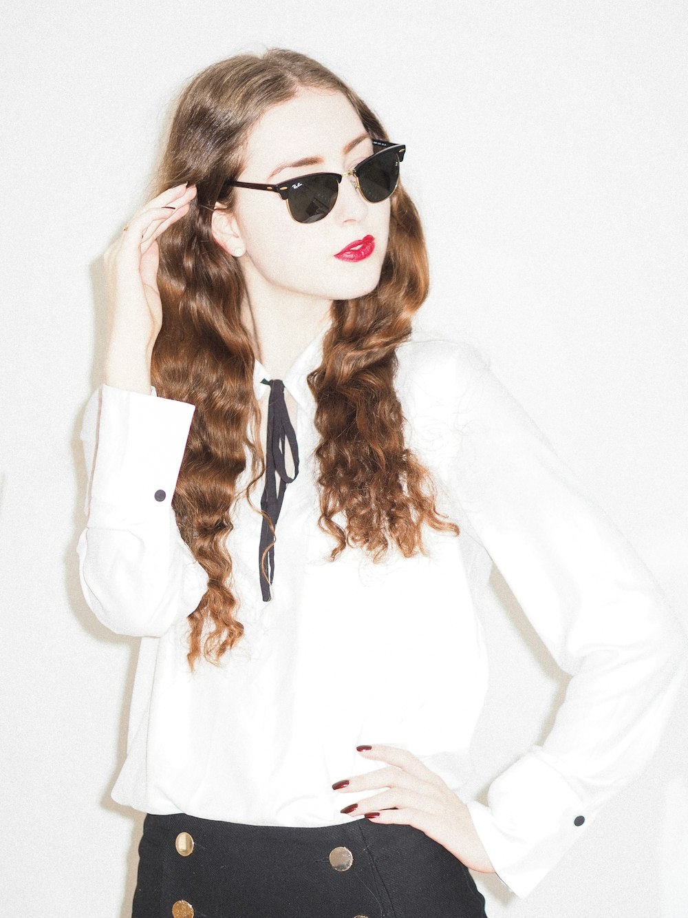 woman in white long sleeve shirt wearing black sunglasses