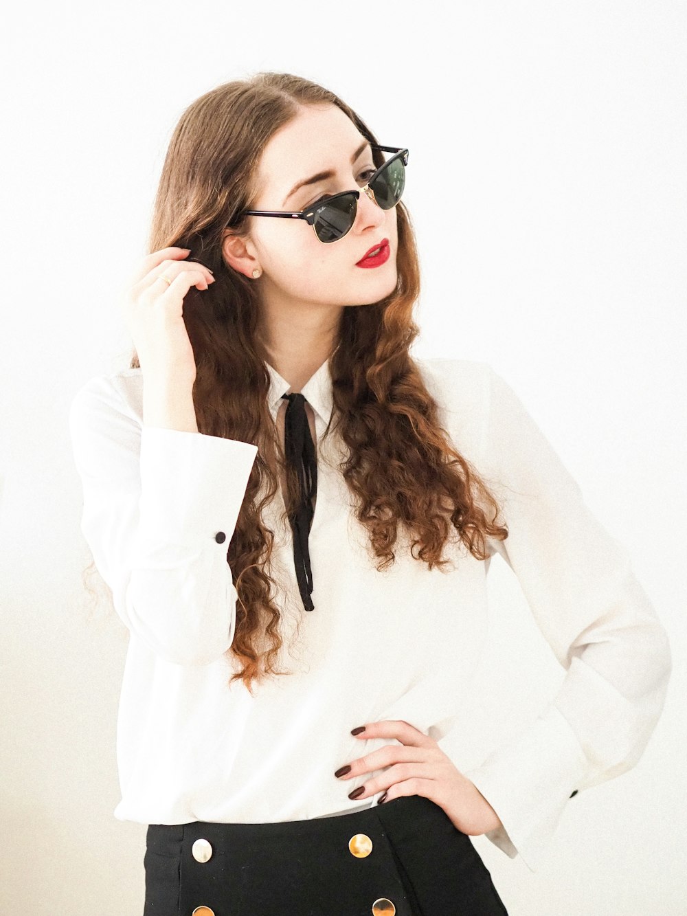 woman in white long sleeve shirt wearing black sunglasses