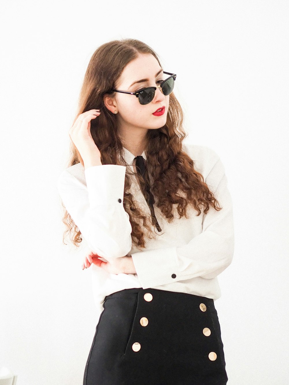 woman in white long sleeve shirt wearing black sunglasses