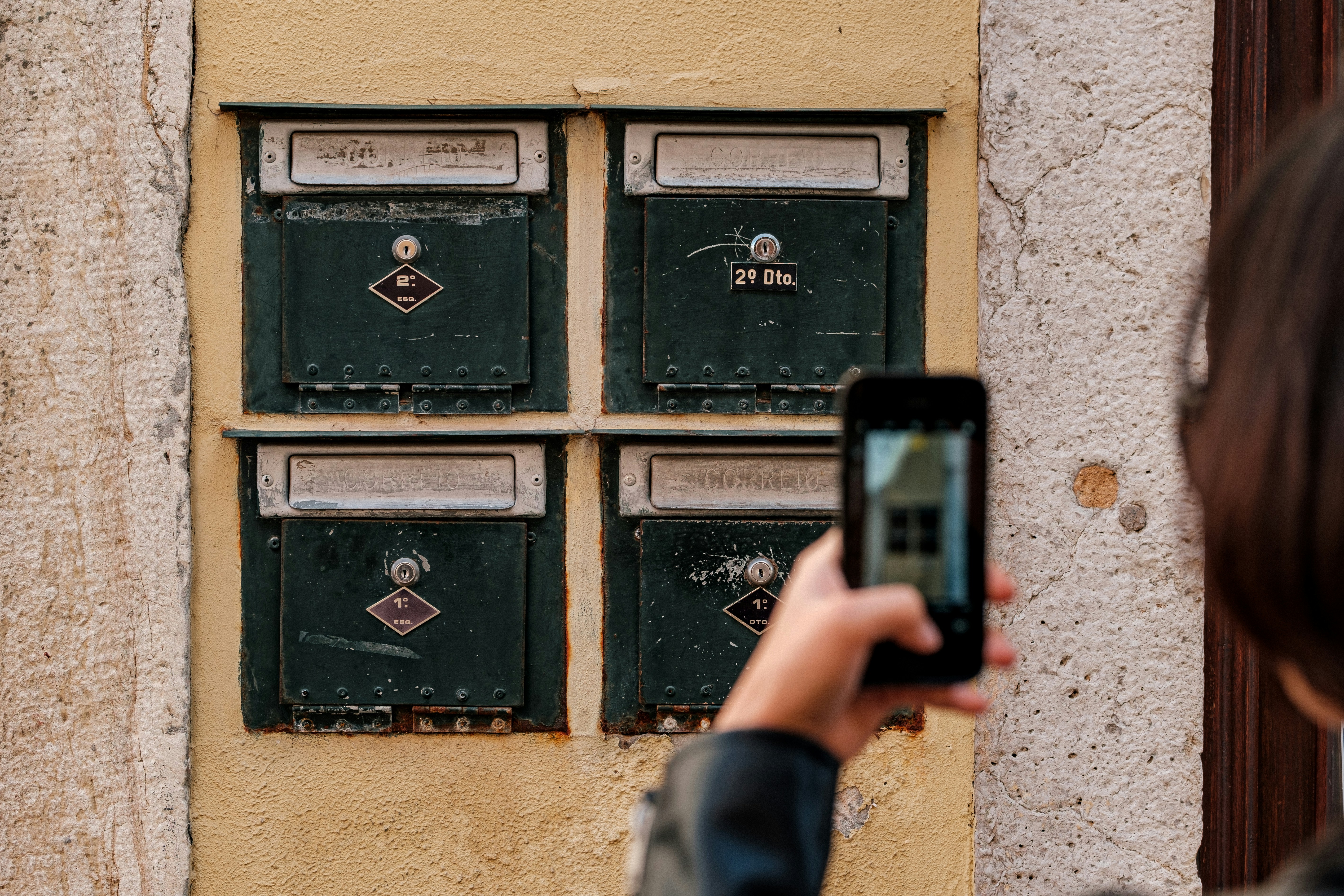 person holding black digital device