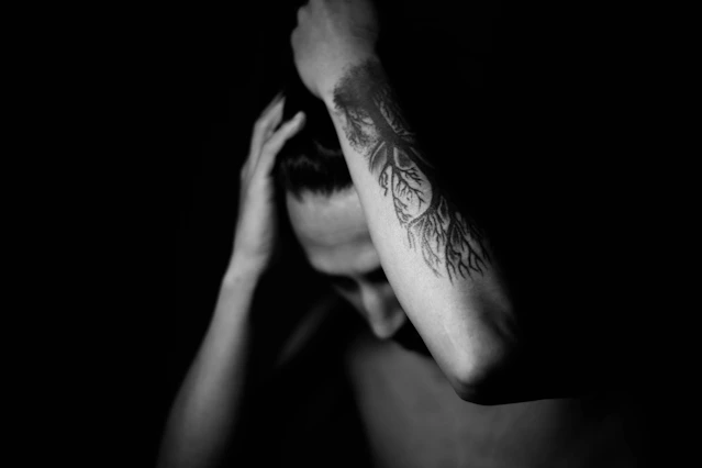 grayscale photo of person with tattoo on right hand