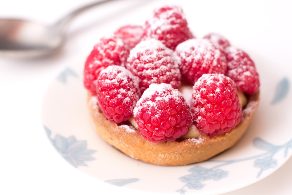 strawberry on brown bread on white ceramic plate