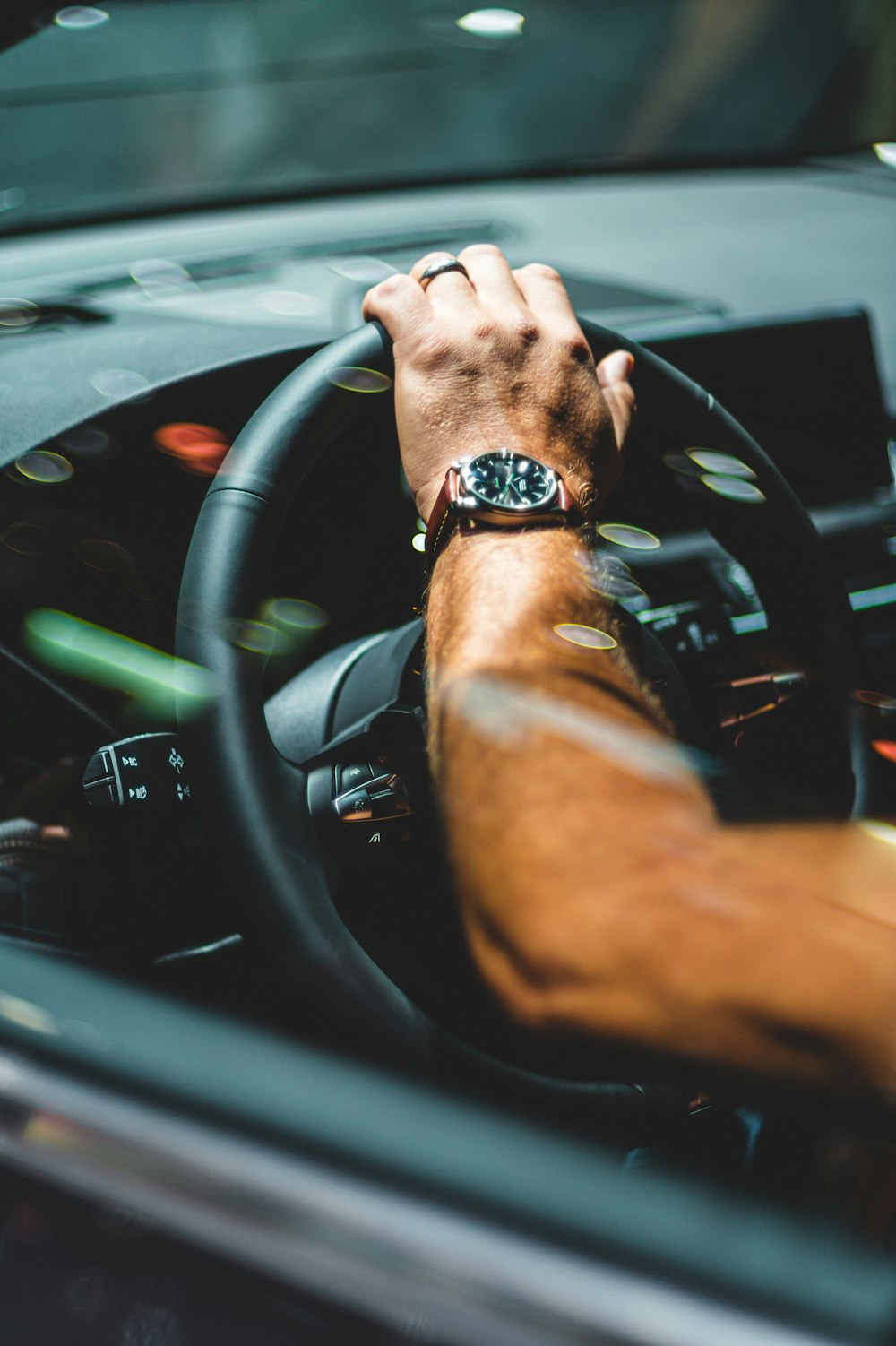 person wearing black watch driving car