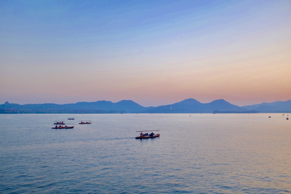 people riding on boat on sea during daytime