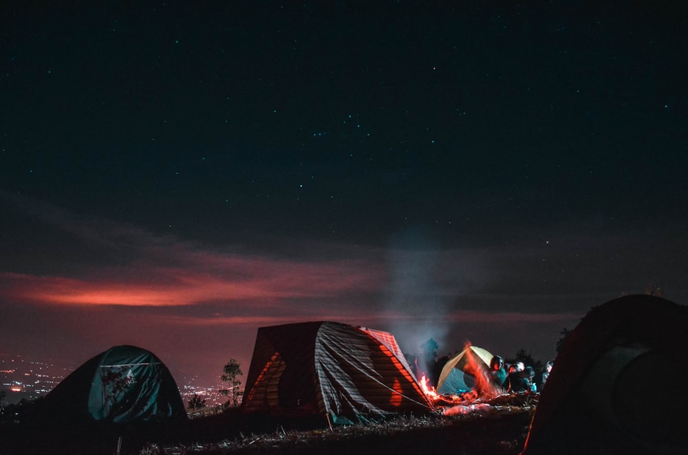 tent on brown field during night time