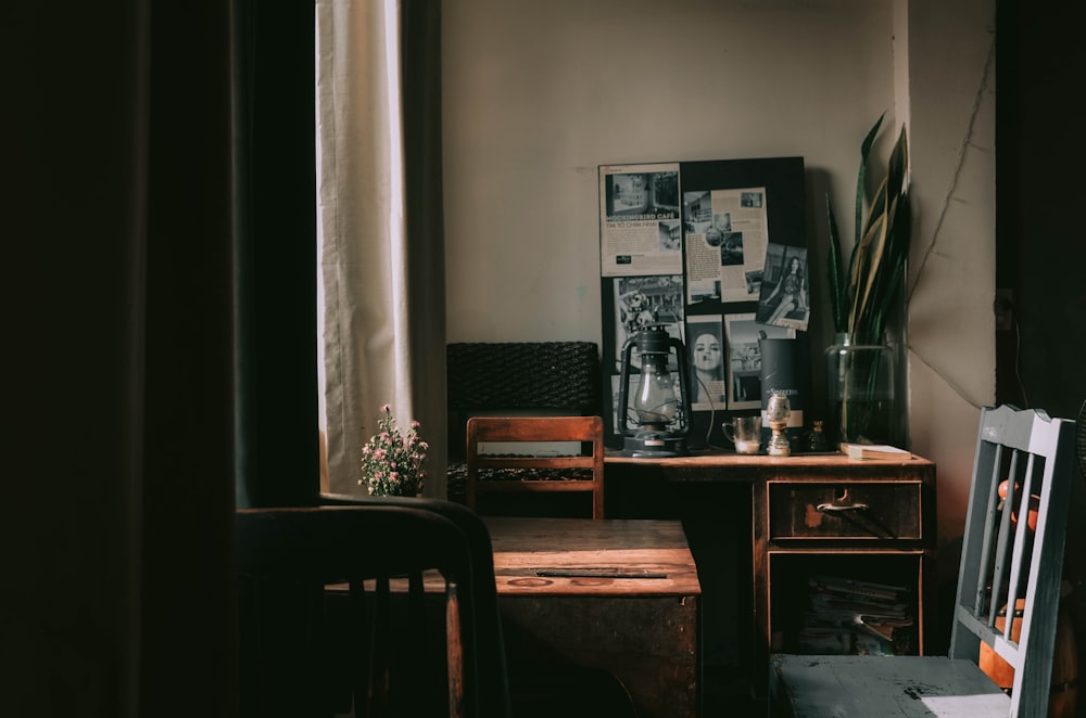 brown wooden table near white window curtain