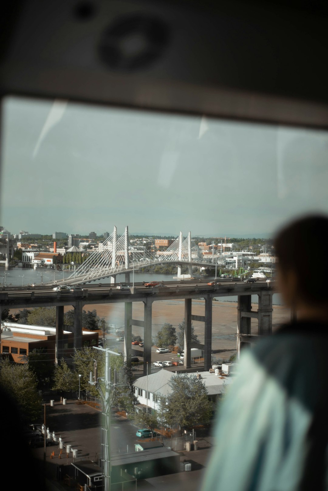 man in green shirt looking at city buildings during daytime