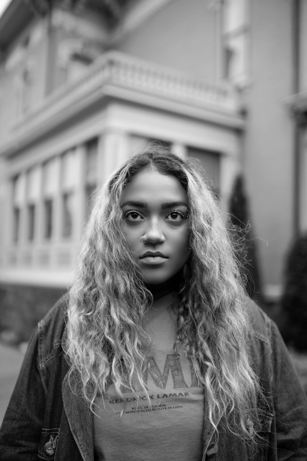 grayscale photo of woman in black coat