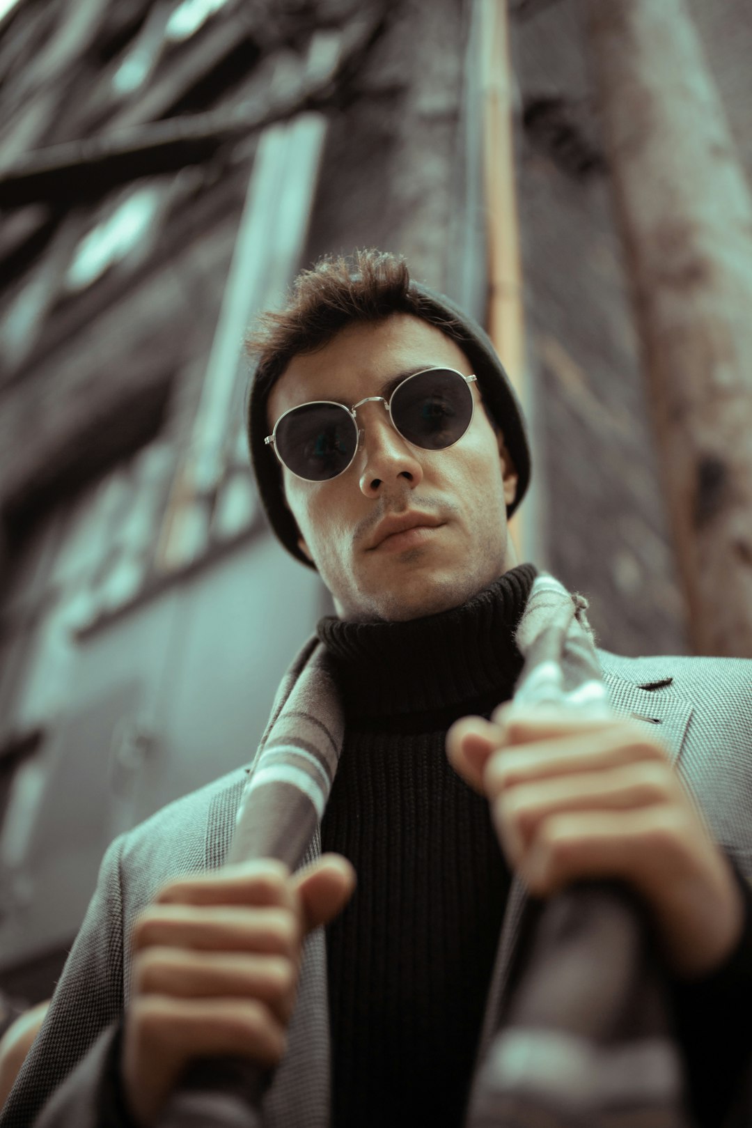 man in black and gray striped turtleneck sweater wearing black sunglasses