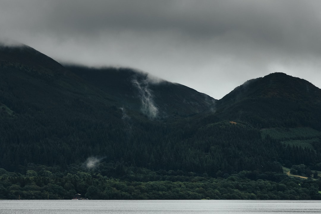 green mountain under white clouds during daytime