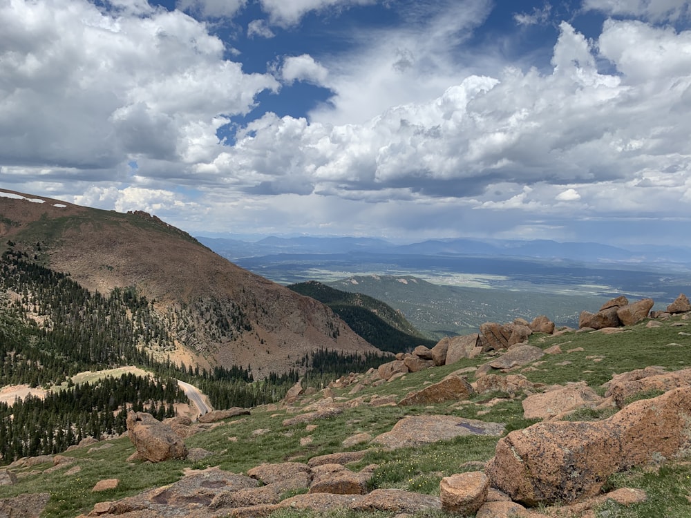 green and brown mountain under white clouds and blue sky during daytime