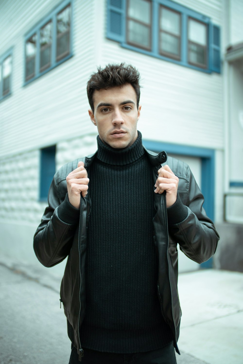 man in black turtleneck sweater and brown jacket