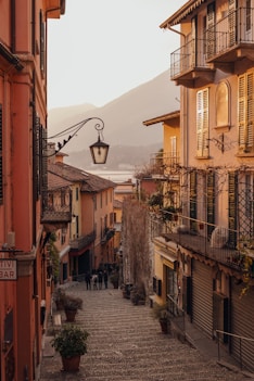 black street light near brown concrete building during daytime in Italy
