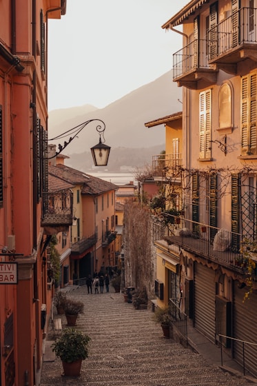 black street light near brown concrete building during daytime in Italy