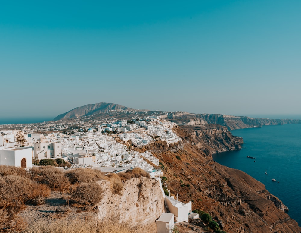 white concrete buildings near body of water during daytime