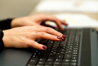 persons hand on black laptop computer
