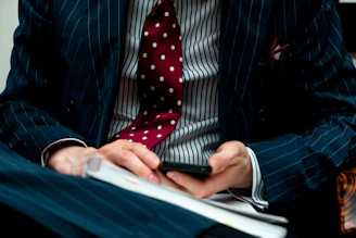 man in black suit jacket using black laptop computer