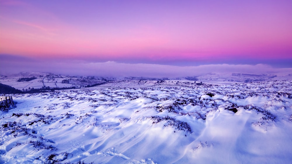 white clouds over snow covered field during daytime