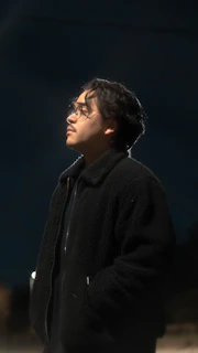 A candid photo of an angel investor thoughtfully reviewing a founder's pitch in a cozy, book-lined study.