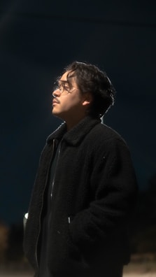 Portrait of a thoughtful person surrounded by glowing AI data streams