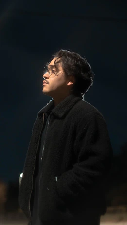 A candid photo of an angel investor thoughtfully reviewing a founder's pitch in a cozy, book-lined study.