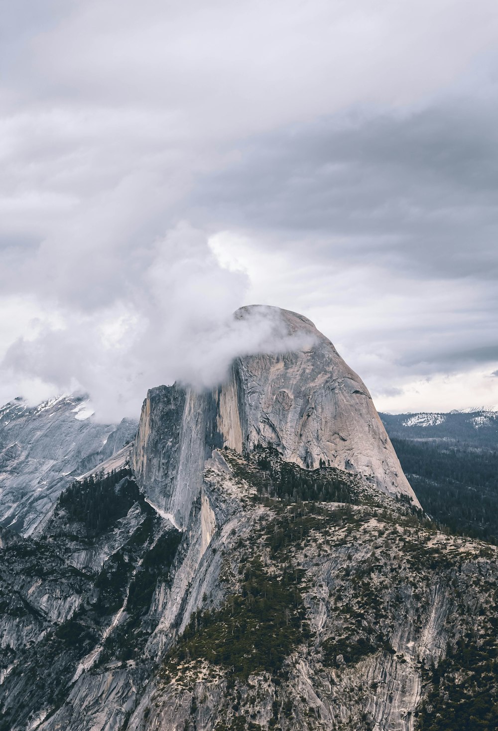 brown and gray rocky mountain under white clouds during daytime