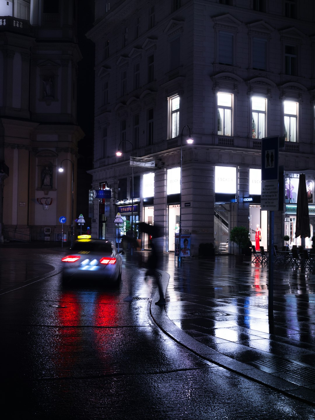 black car on road near building during night time