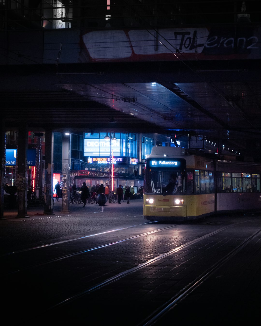 people walking on sidewalk during night time