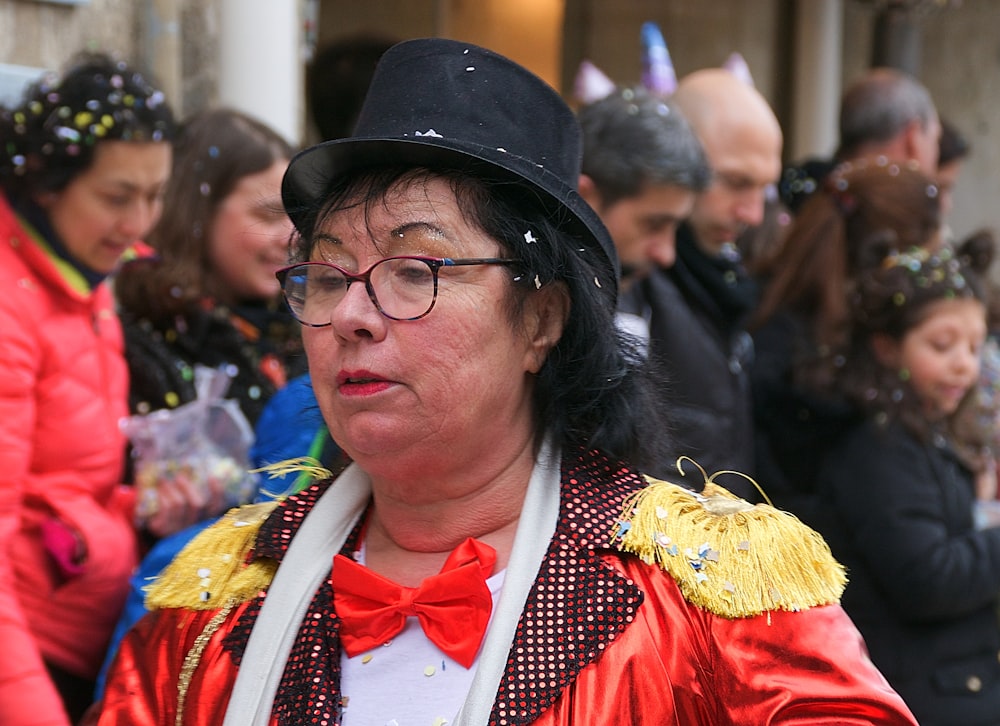 woman in red and yellow dress wearing black hat