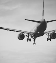 grayscale photo of airplane in mid air