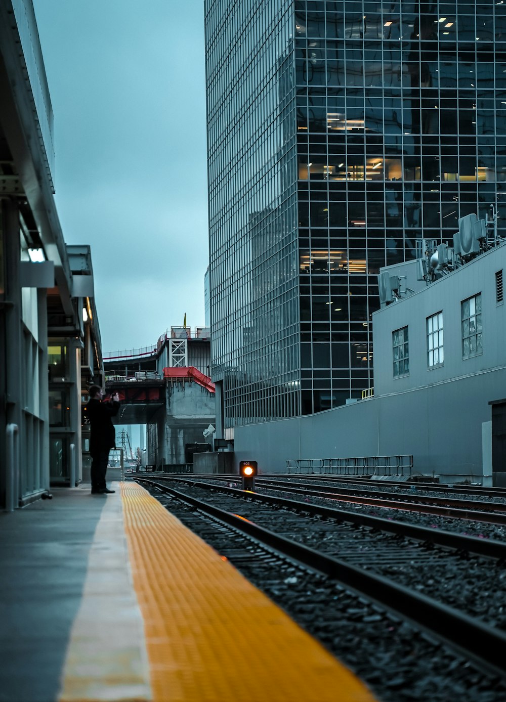 red and white train on rail road between buildings during daytime