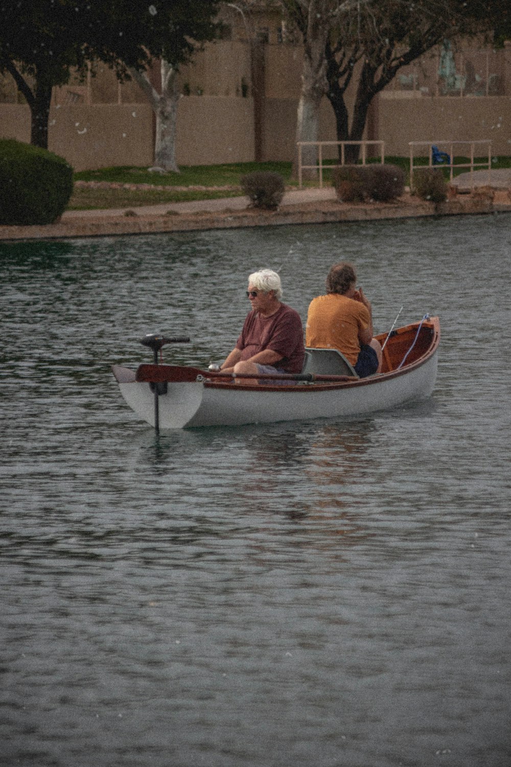 2 men riding on boat during daytime