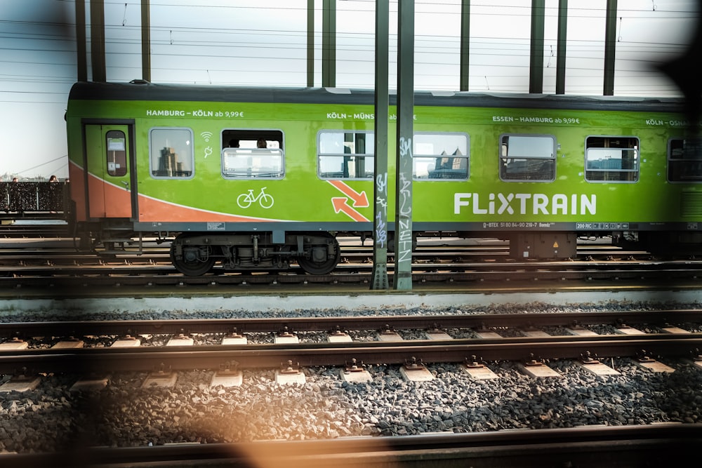 green and yellow train on rail tracks