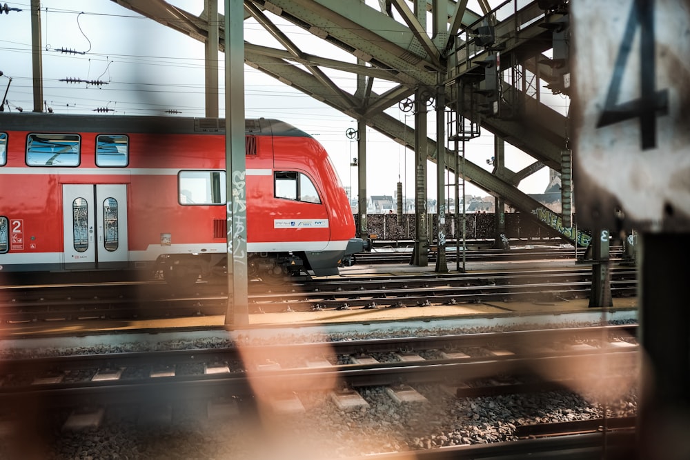 red and white train on train station