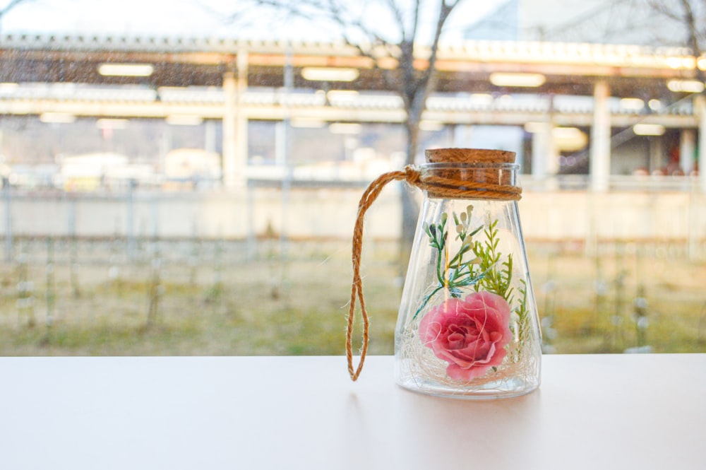 clear glass jar with red liquid inside