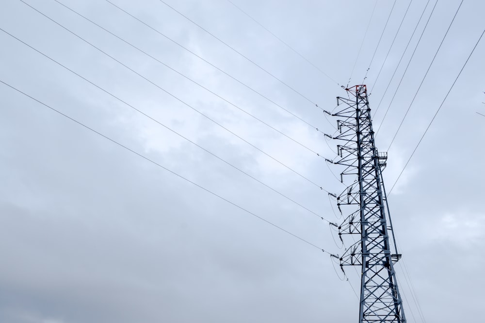 black electric tower under gray sky